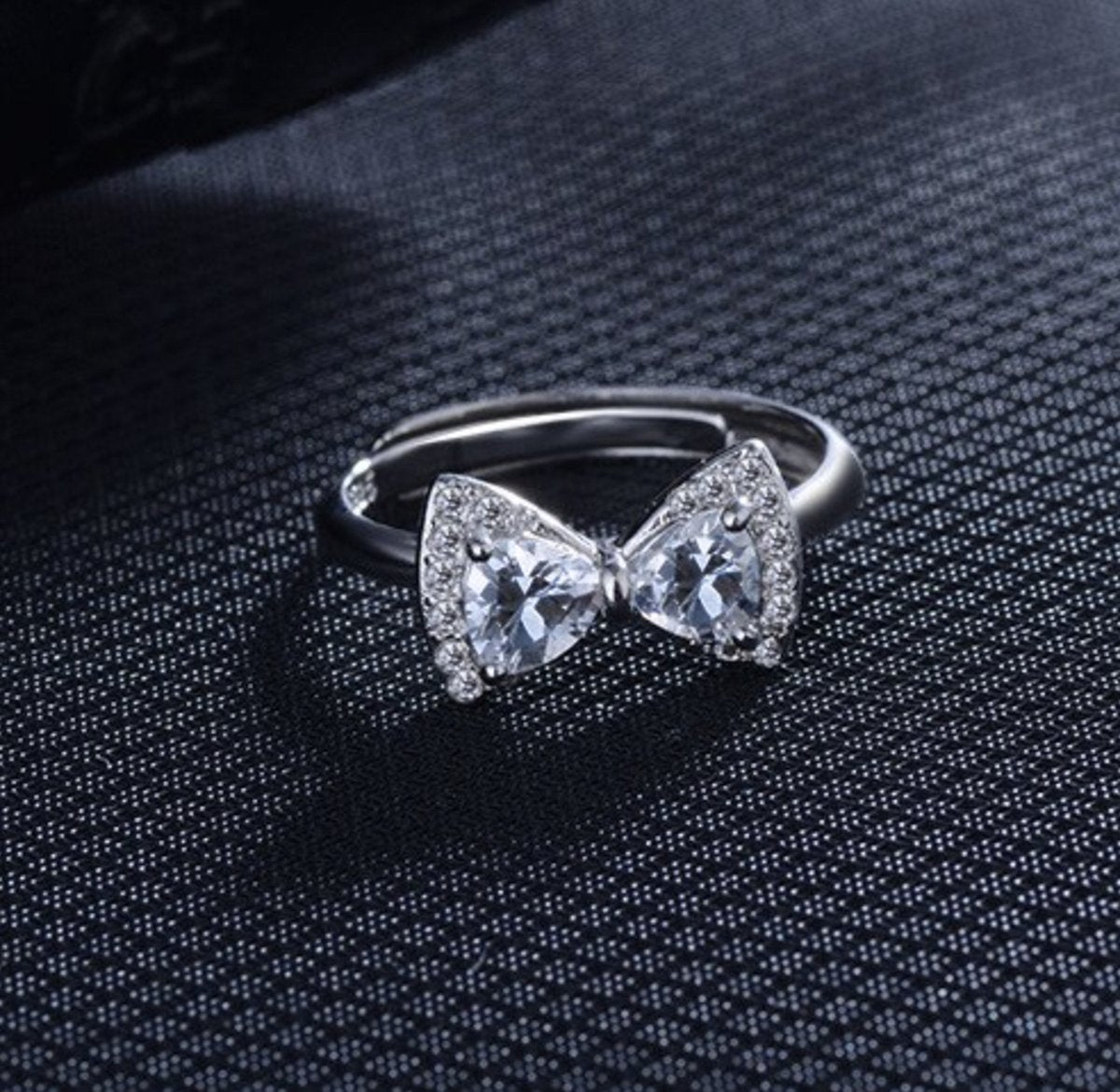 ring met strikje ingelegd met steentjes, zilver